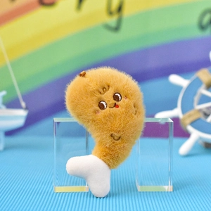 Close-up detail of a cute fuzzy fried chicken leg plush pendant with embroidered face