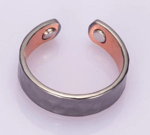 Macro detail of magnetic therapy ring with hammered texture and dual-tone copper finish