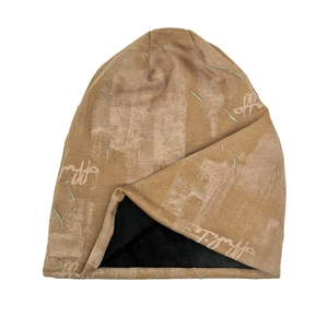 Detail view of khaki knit beanie with brand print and thick black inner lining texture