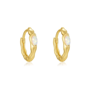 Detail view of gold huggie earrings with marquise iridescent opal drop on white background