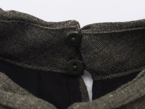 Macro view of back collar detail with double button closure on tweed mini dress