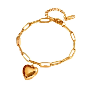 Polished gold heart charm bracelet in stainless steel shown on white background