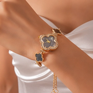 Detail showing crystal-set bezel and gold four-leaf clover-shaped quartz watch for women