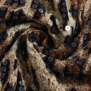 Close-up of leopard print fabric with shimmering sequins on sexy bodysuit material