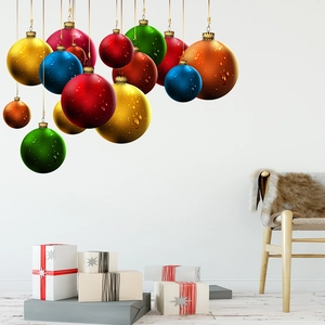 Colorful Christmas ball wall decals on white wall with festive gift boxes and Nordic chair