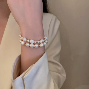 Baroque freshwater pearl double-layer bracelet with gold beads worn on a wrist