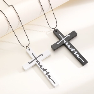 Detail view of black and white wooden cross pendants with faith script on metal bead chain