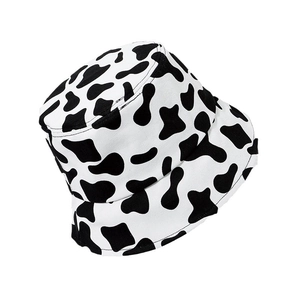 Classic cow print bucket hat in black and white canvas, 45-degree angle product view