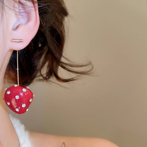 Detail of red resin strawberry earrings with sparkling rhinestones on model's ear