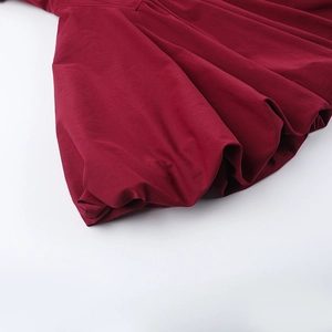Close-up of pleated hem on a wine red square neck sleeveless dress for women