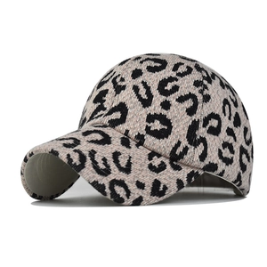 Close-up of thick leopard print knit texture on this warm beige ponytail baseball cap