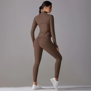 Rear view of tight brown two-piece yoga set with zippered long sleeve jacket and leggings