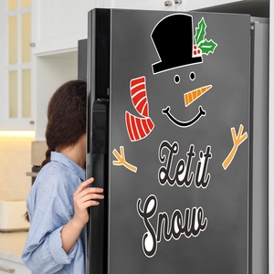 Magnetic snowman fridge sticker set with Let it Snow text on a dark kitchen refrigerator