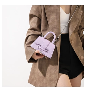 Close-up of purple litchi grain mini bag with silver metallic ball chain strap detail