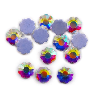Macro shot of AB iridescent flower-shaped flatback crystals for DIY nail art and jewelry