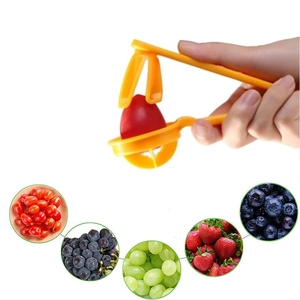 Manual yellow fruit slicer for cherry tomatoes, grapes and strawberries on white background