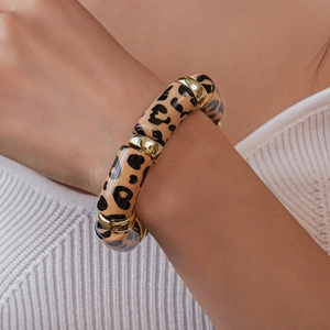 Close-up of acrylic leopard print beaded bracelet with elegant gold-tone metal spacers
