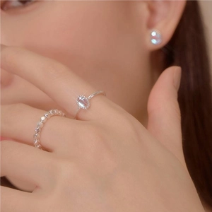 Close-up of elegant 925 silver ring featuring a faceted light blue oval gemstone