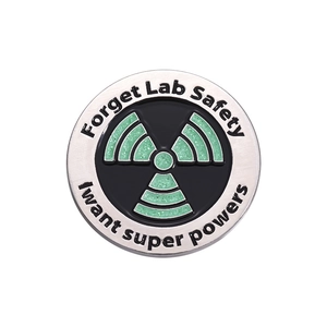 Cartoon round metal badge with green glitter hazard symbol and lab safety slogan
