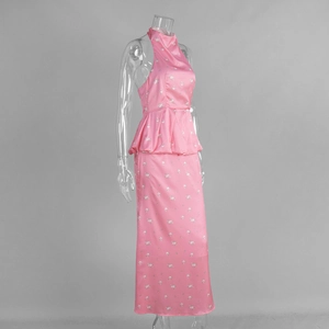 Detail of pink floral satin maxi skirt featuring a peplum waist and halter neck design