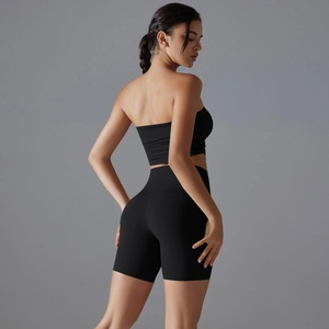 Close-up of black seamless yoga set with high-waist biker shorts and strapless tube top