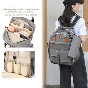 Detail view of the gray diaper backpack with insulated bottle slots and interior storage