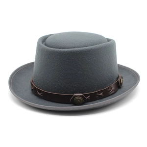 Detail view of the gray wool fedora hat with brown leather band and metal rivets