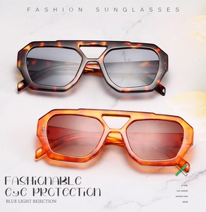 Detail of irregular double-bridge sunglasses with blue light blocking lenses and tortoiseshell frame