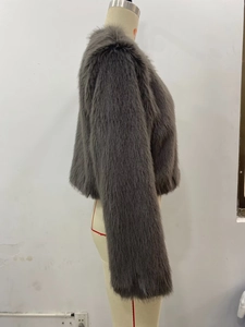 Detail of grey short faux fur jacket showing plush texture and long sleeves on a mannequin