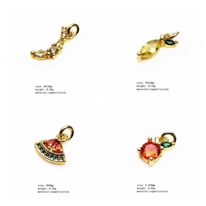 Detailed view of four zircon-encrusted gold pendants in celestial and fruit shapes