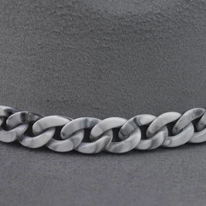 Close-up of grey wool felt fedora hat featuring a stylish marbled resin chain detail