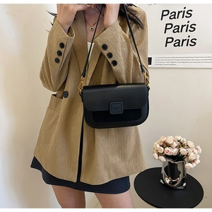 Chic black leather crossbody bag styled with a tailored khaki blazer for a modern look