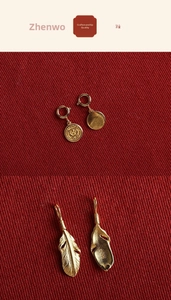 Macro detail of S925 sterling silver gold feather pendant and tiger coin charm