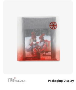 Detailed view of grey knitted neck warmer in WARM ON LIFE branded plastic packaging