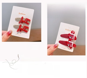 Christmas hair clips set featuring red reindeer and holiday socks on display card