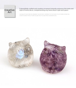 Detail of owl figurines crafted from natural amethyst and moonstone crystal resin