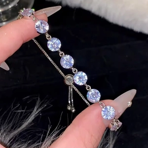 Detailed close-up of a silver-tone bracelet featuring eight round-cut clear zircon stones