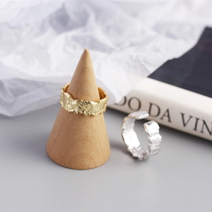 Detailed view of gold and silver S925 rings with irregular hammered foil textures