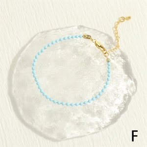 Detail shot of light blue beaded bracelet with gold lobster clasp and extension chain
