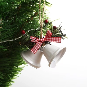 White Christmas bells hanging with red plaid ribbon and pine branch detail