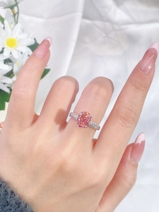 Close-up of S925 silver ring with large oval pink sapphire and pavé-set stones on hand