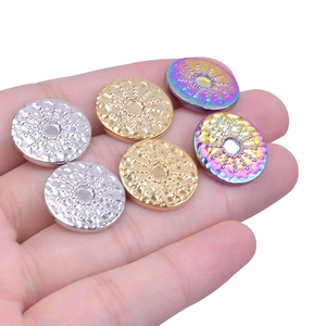 Macro shot of 304 stainless steel studs in gold, silver and rainbow with sunburst texture