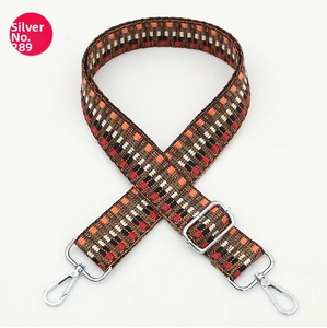 Close-up of geometric woven strap with silver metal hooks and adjustable buckle