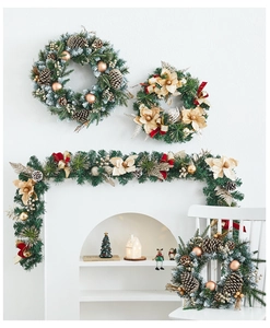 Detailed indoor setting of elegant Christmas wreaths and vines with champagne gold ornaments