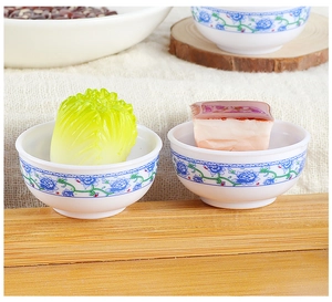 Miniature blue and white porcelain bowls with realistic braised pork and cabbage models