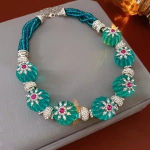 Macro shot of vintage floral turquoise bead necklace with silver clasps and pink gemstones