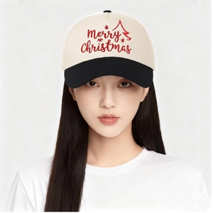 Close-up of Merry Christmas embroidery on a cream and black two-tone trucker hat