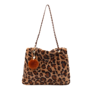 Leopard print plush shoulder bag with gold chain strap and decorative pompom charm