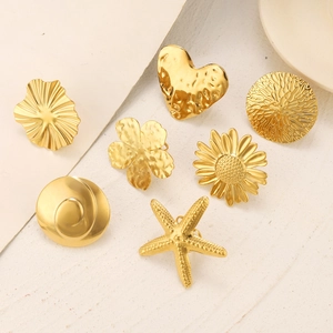 Golden stainless steel rings set with embossed sunflower starfish and heart designs