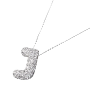 Macro shot of silver letter J pendant featuring pave setting cubic zirconia on fine chain